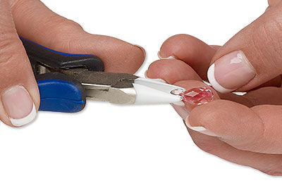 Pinching bail onto the crystal with white tipped pliers